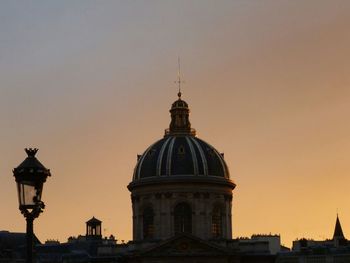 Low angle view of building against sky at sunset
