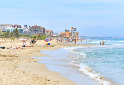 People on beach against sky