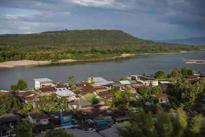 High angle view of townscape by sea against sky