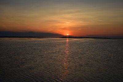 Scenic view of sea against romantic sky at sunset