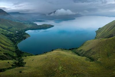 High angle view of land and mountains against sky