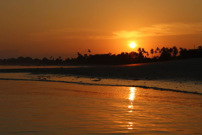 Scenic view of sea against romantic sky at sunset