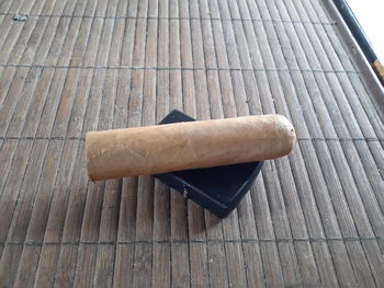 High angle view of cigarette on wooden table