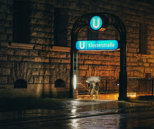 Information sign on wall at night