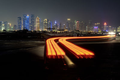 Doha skyline with light trail corniche road