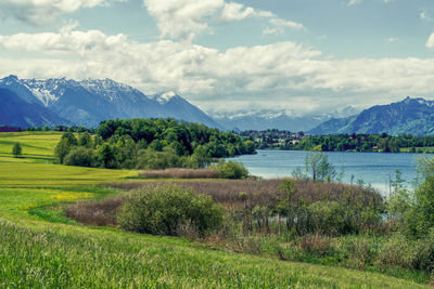 Scenic view of lake and mountains against sky