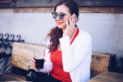 Young woman drinking glass with drink