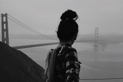 Rear view of young woman looking at golden gate bridge