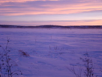 Scenic view of snow covered landscape against sky