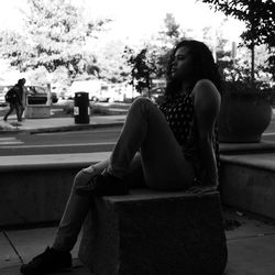 Woman sitting on rock at public park