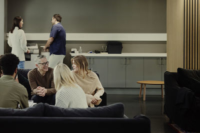 Group of business people having meeting in lobby