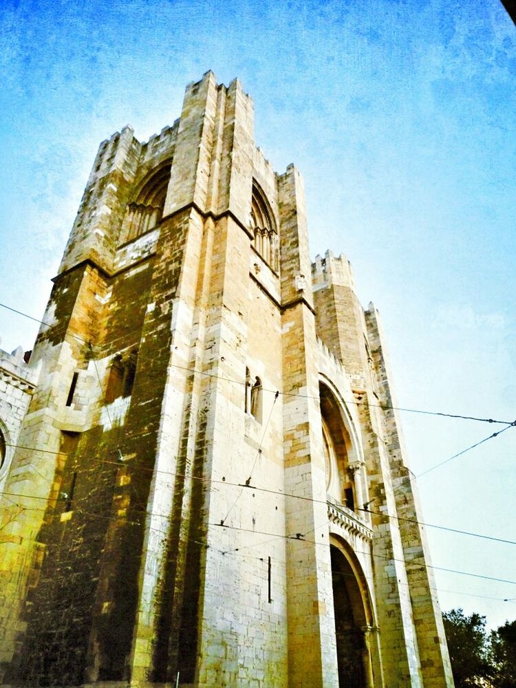 architecture, low angle view, built structure, building exterior, sky, window, building, city, no people, old, outdoors, blue, tower, day, history, church, glass - material, facade, arch, sunlight