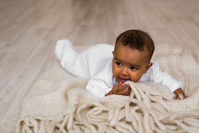 Portrait of cute boy lying on sofa