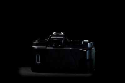 Close-up of camera against black background