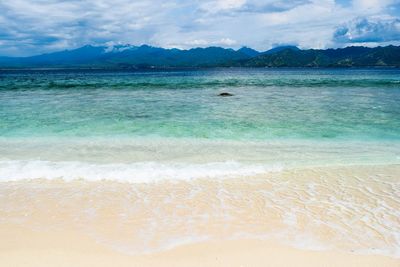 View of beach against cloudy sky