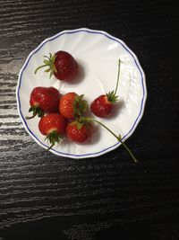 High angle view of strawberries in bowl on table