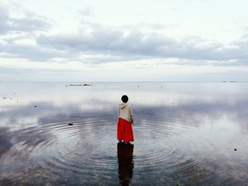 Rear view of woman in calm sea
