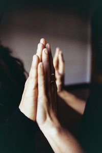 Close-up of couples hands clasped together at home