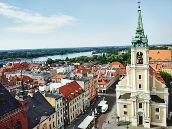 High angle view of cityscape by sea against sky