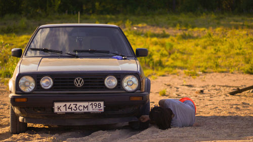 Man driving car on field