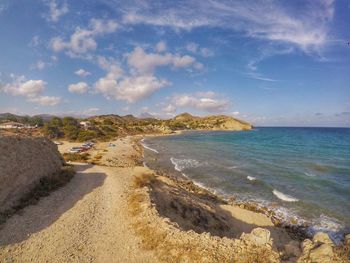 Scenic view of beach against blue sky