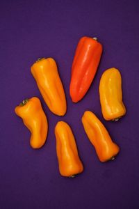 High angle view of yellow pepper against blue background