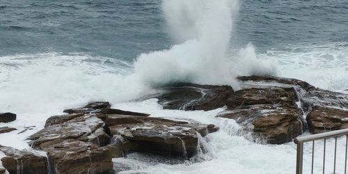 Waves splashing on rocks at sea