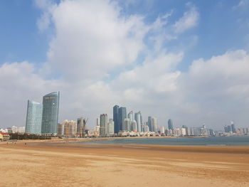 View of beach with city in background