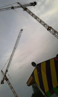 Low angle view of crane against sky