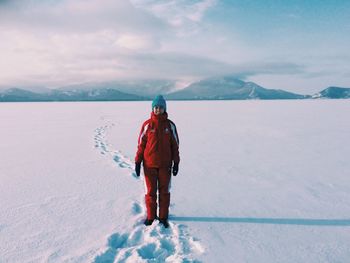 Rear view of person on snow against sky