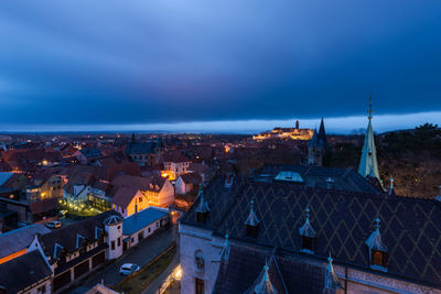 High angle view of illuminated buildings in city at night