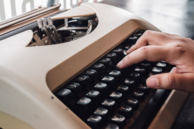 Cropped hand using typewriter