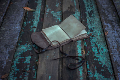 High angle view of old diary on wooden table