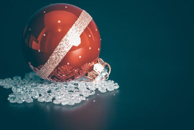 Close-up of bauble on colored background