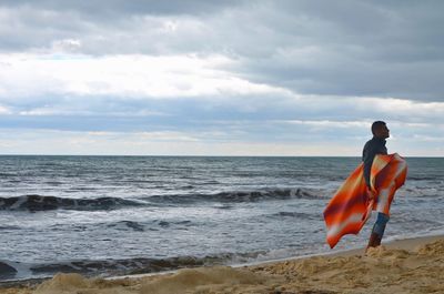 Man looking at sea against sky
