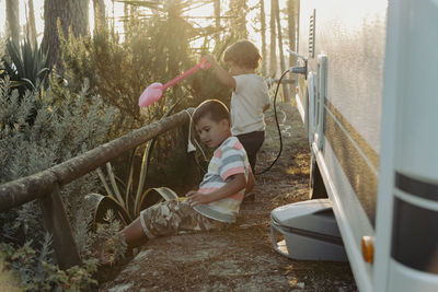 Two boys in a caravan playing in the nature