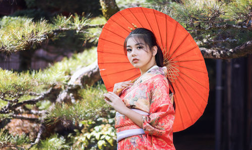 Portrait of girl holding umbrella