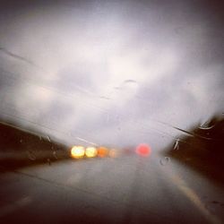 Illuminated road against sky at night