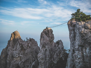 Low angle view of rock formation against sky