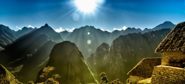 Panoramic view of mountains against sky on sunny day