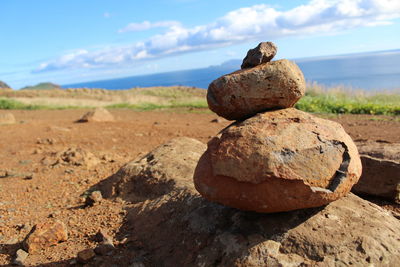 Stack of rocks on beach against sky