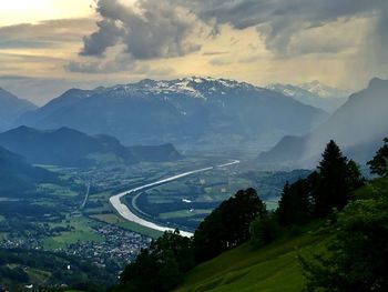 Scenic view of mountains and river against sky