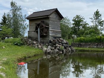 Built structure by lake against sky