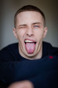 Portrait of man sticking out tongue