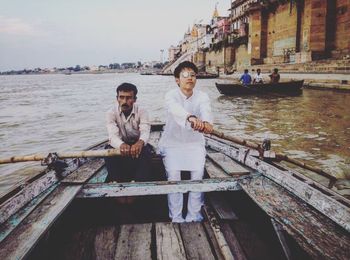 People sitting on boat in river