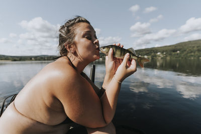 Woman kissing fish