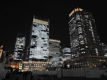 Low angle view of skyscrapers lit up at night