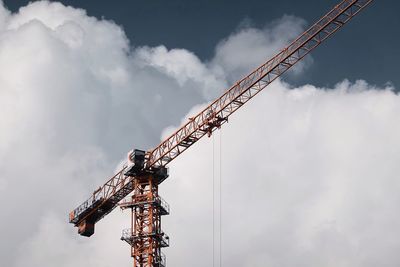 Low angle view of crane against sky