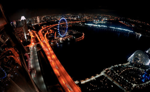 High angle view of city lit up at night