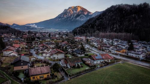 High angle view of townscape and mountains against sky